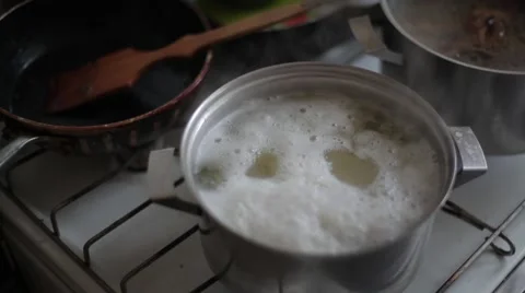 The potatoes cook in the pan and with a spoon remove foam Stock Footage 59798865