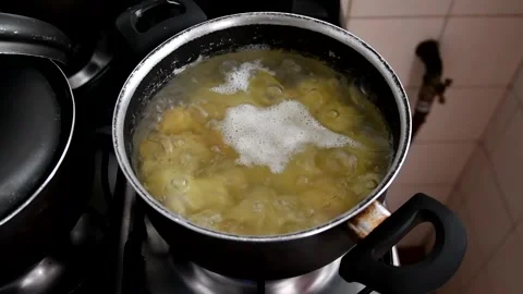 Potatoes cooking in boiling water Stock Footage