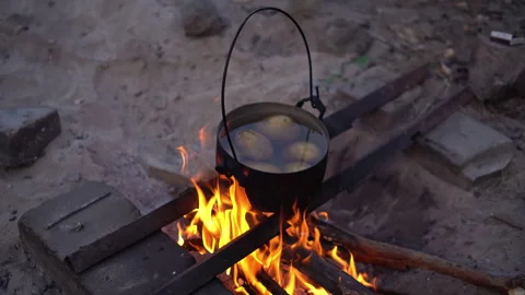 Potatoes cooking in pot over fire Stock Footage 285300252