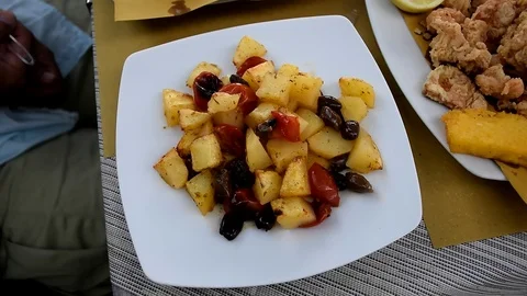 Potatoes dish with cherry tomatoes and black olives Stock Footage 112647225