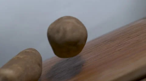 Potatoes dropping in slow motion onto a cutting board - static Stock Footage 64834309