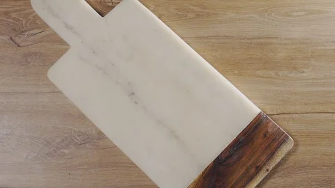 Potatoes fall in slow motion to the rock board on the table, falling vegetables Stock Footage 104978555