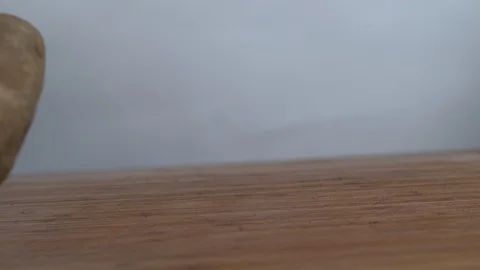 Potatoes falling on chopping board in slow motion Stock Footage 100007748