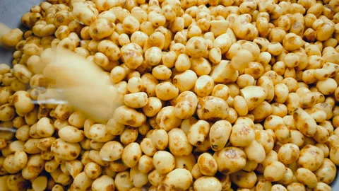 Potatoes falling into a container, stored in piles at a food factory. Stock Footage 104977705