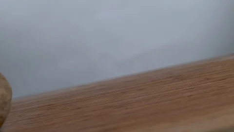 Potatoes falling in slow motion onto a cutting board Stock Footage 100007772