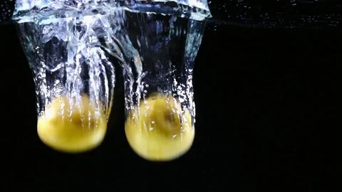 Potatoes falling into the water in slow motion Stock Footage 76950863