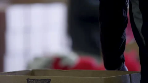 Potatoes getting put in a bag at a charity food bank during COVID-19 pandemic Video stock 130993525