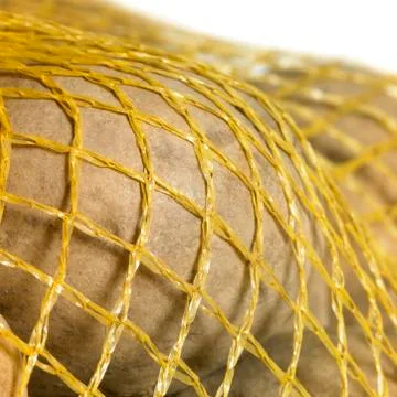 Potatoes in a net Stock Photos