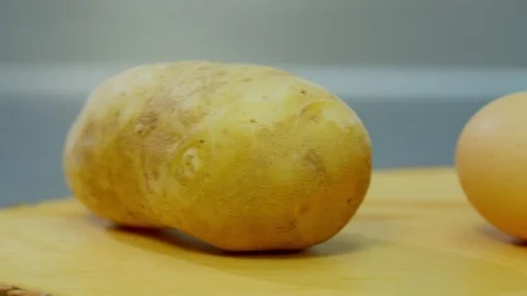 Potatoes, onion, egg and flour lying on a wooden stand Stock Footage 70964661