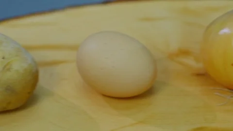 Potatoes, onion, egg and flour lying on a wooden stand Stock Footage 70966754