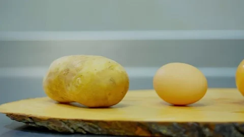 Potatoes, onion, egg and flour lying on a wooden stand Stock Footage 70968477