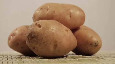 Potatoes rotating on light background Stock Footage 69947296