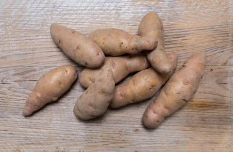 Potatoes on rustic wood Concept Stock Photos