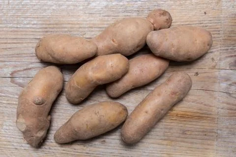 Potatoes on rustic wood Concept Stock Photos