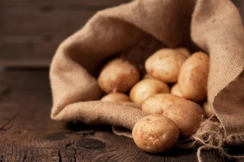 Potatoes in sack Stock Photos