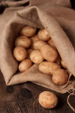 Potatoes in sack Stock Photos