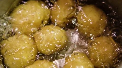 Potatoes with skin boiling in a pot Stock Footage 79542046
