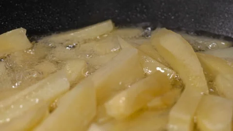 Potatoes sliced fried in a pan, close-up Stock Footage 87620450