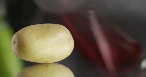 Potatoes spin on a mirror surface Stock Footage 198345739