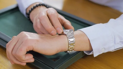 Potential watch buyer fitting a fine, vintage Rolex before making a Stock Footage 105539780