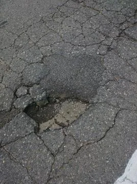 A pothole in the pavement Stock Photos