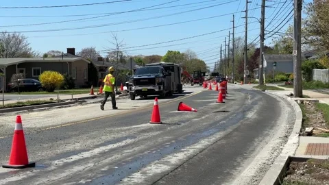 Pothole repair - maintenance workers work on a road in Dartmouth, Canada. Stock Footage 277418844