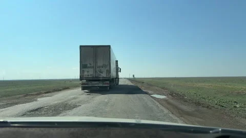 The potholed Uralsk-Atyrau highway with deep potholes. Stock Footage 332208822