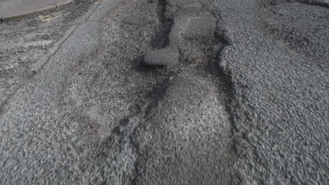 Potholes on damaged asphalt road in need of repair Stock Footage 331303283