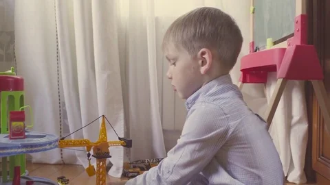 Potrait of a boy playing with toy jenny Stock Footage 76396299