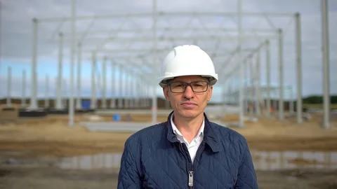 Potrtait of male engineer architect supervisor in hard hats and looking at Stock Footage 98363851