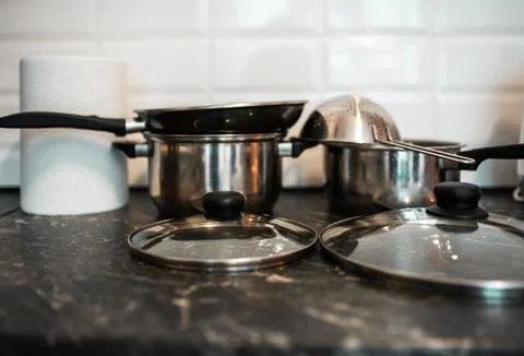 Pots and other kitchenware on a kitchentop. Clean kitchen concept. Stock Photos