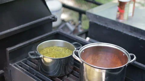 Pots cooking on the grill Stock Footage 50542999