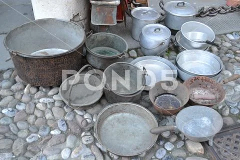 Pots of different sizes and made of different metals exposed for sale. Stock Photos