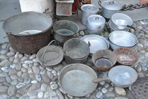 Pots of different sizes and made of different metals exposed for sale. Stock Photos