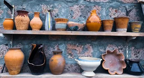 Pots of different types and colors on shelves Stockfoto's