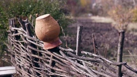 Pots on a wicker fence. Stock Footage 70732181