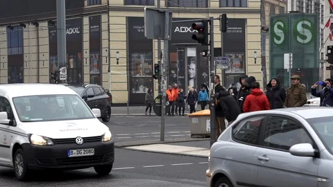 Potsdamer Platz on a cloudy winter day while people wait to cross the road and Stock Footage 127341397