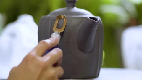 Potter adding details to clay teapot Stock Footage 312465239