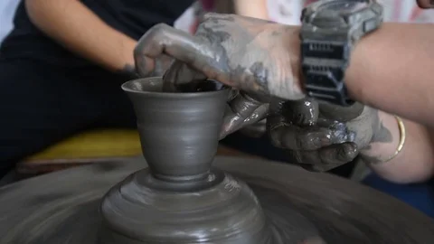 Potter Artisan teaching how to create a cup on pottery wheel in Asia Stock Footage 79837859