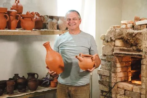 Potter in authentic workshop. Stock Photos