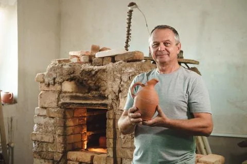 Potter in authentic workshop. Stock Photos