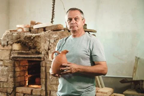 Potter in authentic workshop. Stock Photos