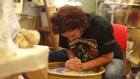 Potter centering clay on throwing wheel Stock Footage 71939898