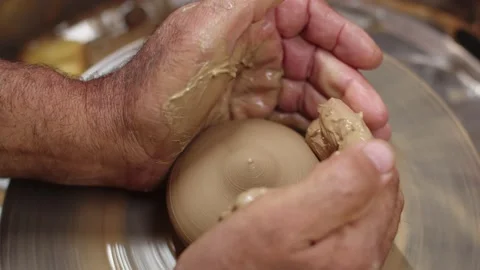 Potter creates ceramic product from clay on potter's wheel in his workshop Stock Footage 158314555