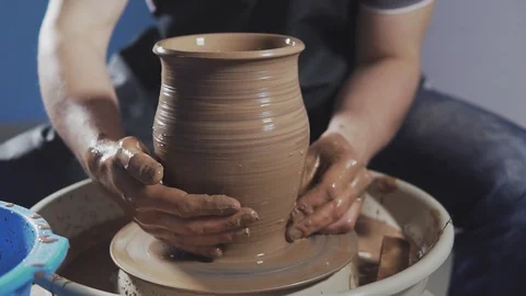 Potter creates jug. Hands gently create correctly shaped handmade from clay Stock Footage 114314587