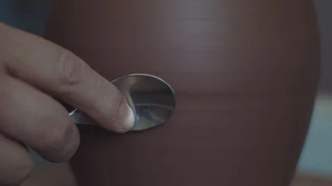 Potter creates lines on a jug Stock Footage 109287125