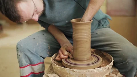 Potter creating clay jar vase earthenware on twisting wheel top view indoors  스톡 동영상 87219101