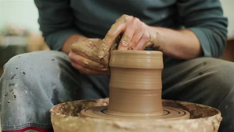 Potter creating clay jar vase earthenware on twisting wheel top view indoors  스톡 동영상 87319228