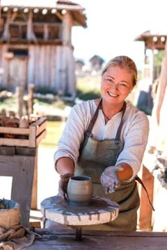 Potter is creating earthenware on potter's wheel. Stock Photos