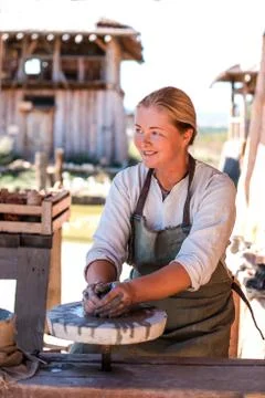 Potter is creating earthenware on potter's wheel. Stock Photos